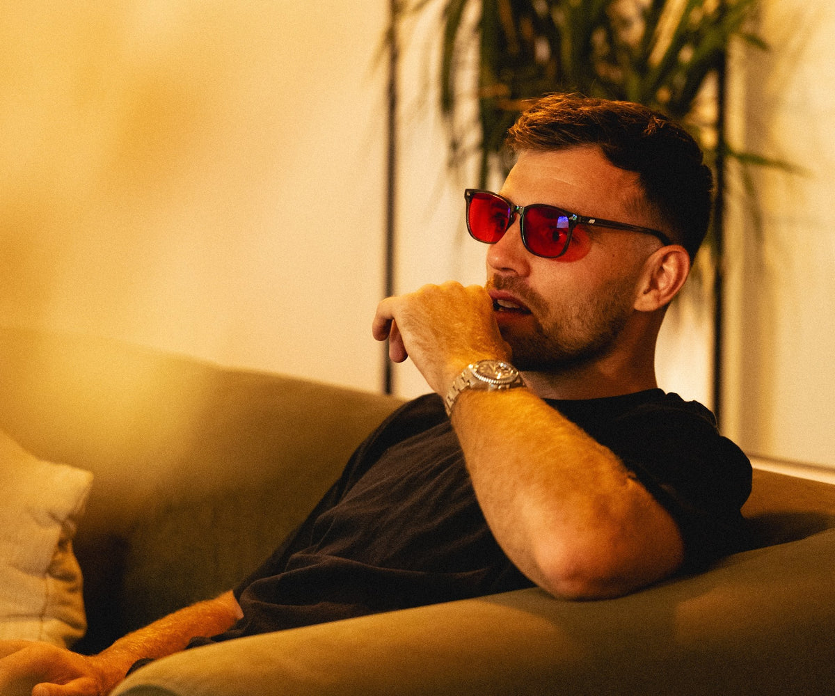 Ben White relaxing on the sofa in blue-light glasses