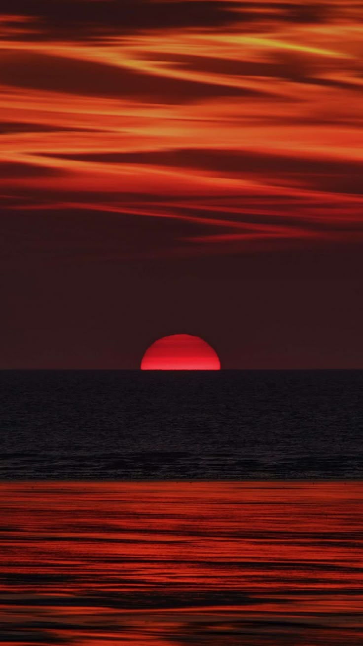 The sun setting over the sea