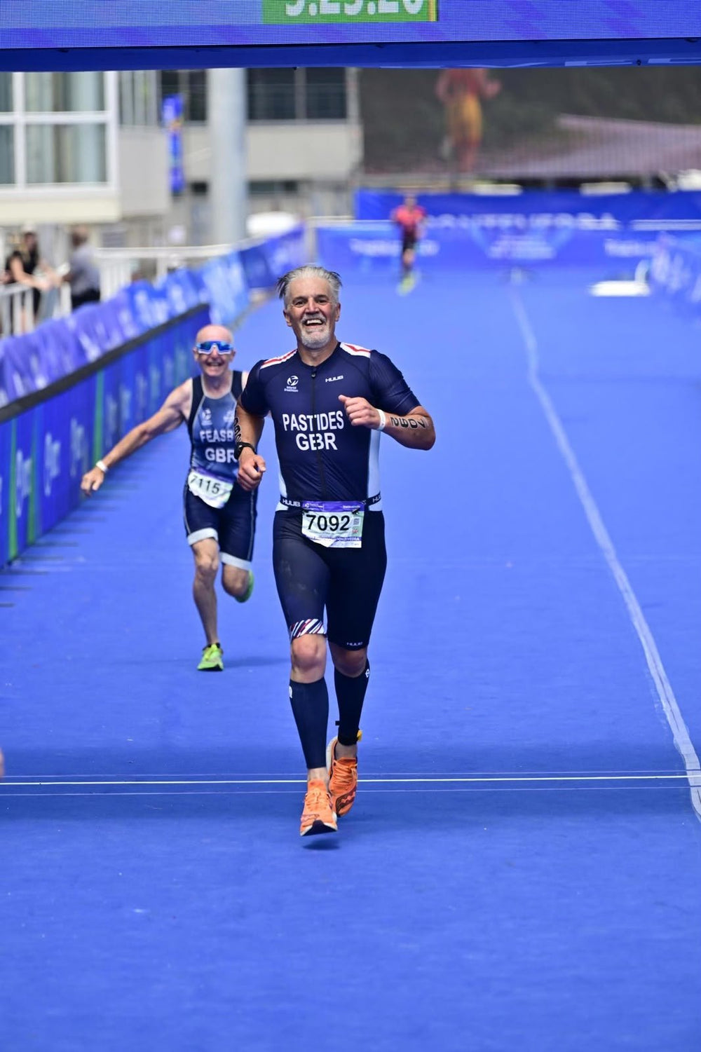 Pete crossing a triathlon finish line
