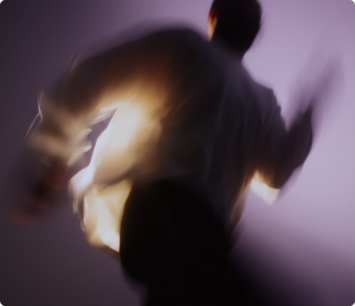 Blurred figure moving through warm light