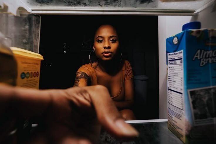 Late-night snack at an open fridge